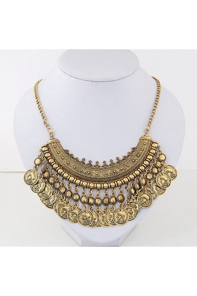 Bohemian Style Coin Necklace in antique gold finish with intricate details is shown on jewelry display
